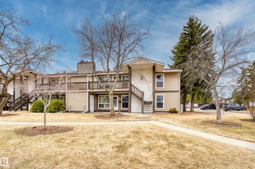Multi-level residential building featuring tan siding and white stucco accents - 1116 Saddleback Road, Edmonton, AB - Outdoor