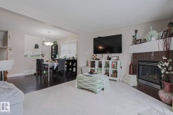 Living area featuring a fireplace with a tiled surround and white mantel - 