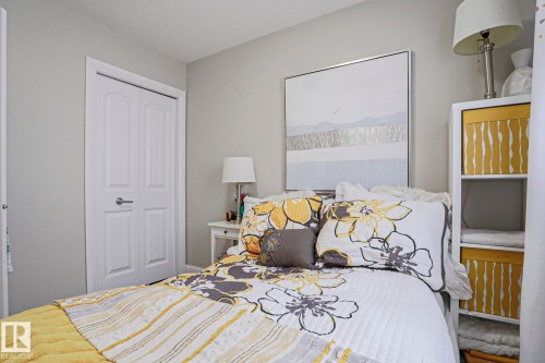 Neutral-toned walls complement white trim and a two-panel closet door - 1621 64 Street, Edmonton, AB - Indoor Photo Showing Bedroom