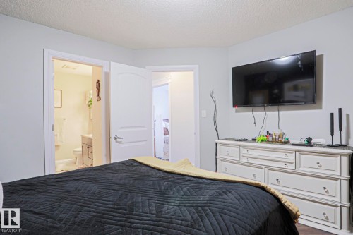 Bedroom featuring light gray walls, wood-finish flooring, and white trim - 1621 64 Street, Edmonton, AB - Indoor Photo Showing Bedroom