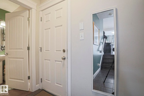 White paneled doors with chrome hardware and a full-length mirror - 1621 64 Street, Edmonton, AB - Indoor Photo Showing Other Room