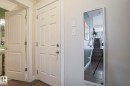White paneled doors with chrome hardware and a full-length mirror - 1621 64 Street, Edmonton, AB  - Indoor Photo Showing Other Room 