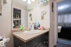 Bathroom vanity featuring a single basin, laminate countertop, and dark wood-finish cabinetry - 