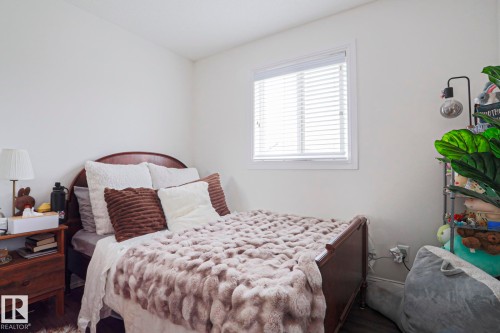 Bedroom featuring white walls and dark wood-finish flooring - 1621 64 Street, Edmonton, AB - Indoor Photo Showing Bedroom