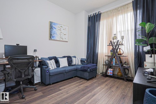 Interior space featuring wood-finish flooring, white walls, and a large window with floor-to-ceiling curtain rods - 1621 64 Street, Edmonton, AB - Indoor Photo Showing Office