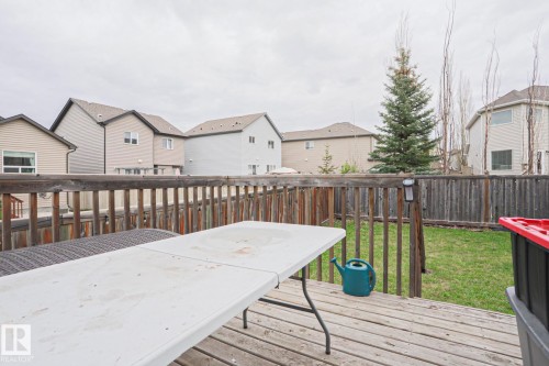Expansive wood deck with a full wood railing, overlooking a green lawn - 1621 64 Street, Edmonton, AB - Outdoor With Deck Patio Veranda With Exterior