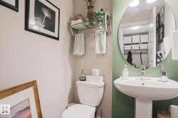 Pedestal sink with chrome faucet and circular mirror - 