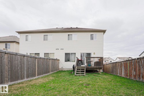 Expansive backyard featuring a wood deck with stairs, a manicured lawn, and perimeter wood fencing - 1621 64 Street, Edmonton, AB - Outdoor With Deck Patio Veranda With Exterior
