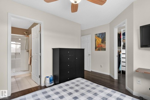 Bedroom featuring wood-finish flooring, a ceiling fan with integrated lighting, and a neutral wall color - 16 7503 Getty Gate, Edmonton, AB - Indoor Photo Showing Bedroom