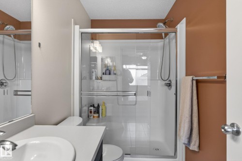 Shower enclosure featuring clear glass panels and a white shower base - 16 7503 Getty Gate, Edmonton, AB - Indoor Photo Showing Bathroom