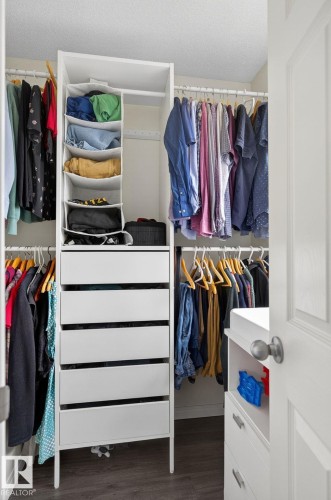 Custom closet system featuring white shelving units - 16 7503 Getty Gate, Edmonton, AB - Indoor With Storage