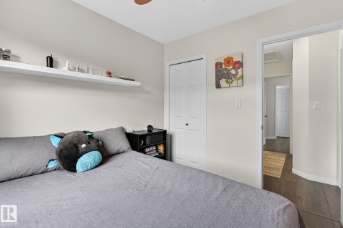 Bedroom featuring light-colored walls and wood-finish flooring - 16 7503 Getty Gate, Edmonton, AB - Indoor Photo Showing Bedroom