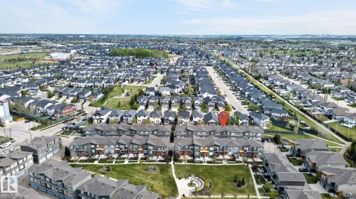 Expansive aerial showcasing a residential neighborhood with numerous detached and attached homes - 16 7503 Getty Gate, Edmonton, AB - Outdoor With View