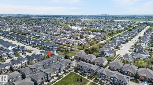 Aerial perspective featuring a residential development with multiple rows of townhomes and detached properties - 16 7503 Getty Gate, Edmonton, AB - Outdoor With View