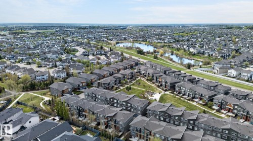 Expansive residential area featuring diverse housing styles, including single-family residences and multi-story townhomes - 16 7503 Getty Gate, Edmonton, AB - Outdoor With View