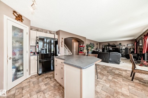 Kitchen island featuring a hexagonal countertop and integrated cabinetry - 5107 200 Street, Edmonton, AB - Indoor