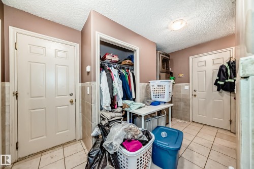 Dedicated laundry area featuring tile flooring. - 5107 200 Street, Edmonton, AB - Indoor Photo Showing Other Room