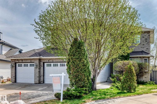 Two-story residence featuring a brick facade and a triple car garage. - 5107 200 Street, Edmonton, AB - Outdoor