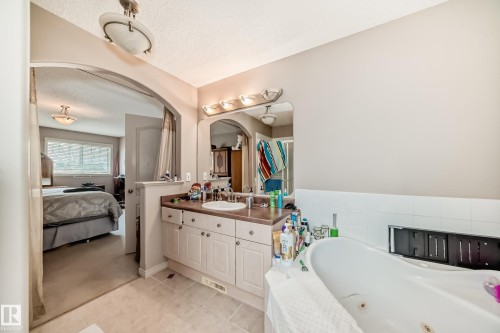 Bathroom featuring a white vanity with built-in storage, a drop-in sink, and a countertop - 5107 200 Street, Edmonton, AB - Indoor Photo Showing Bathroom