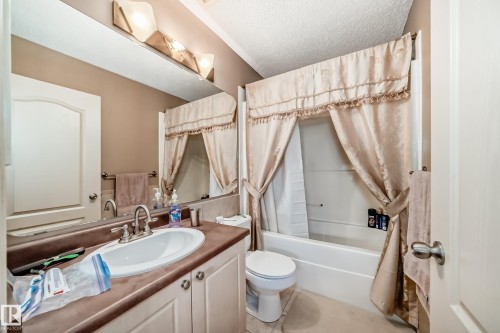 Bathroom featuring a single vanity with an integrated sink. - 5107 200 Street, Edmonton, AB - Indoor Photo Showing Bathroom
