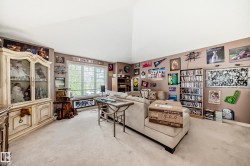 Spacious interior with vaulted ceilings and neutral carpeting - 