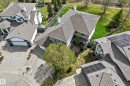 Aerial perspective showcasing a residential property with a multi-car driveway, triple attached garage, and pitched shingle roof - 5107 200 Street, Edmonton, AB  - Outdoor 