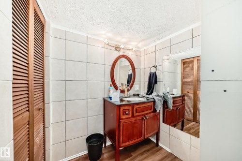 Bathroom vanity featuring a dark wood-finish cabinet. - 5107 200 Street, Edmonton, AB - Indoor