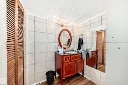 Bathroom vanity featuring a dark wood-finish cabinet. - 