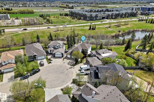 Aerial perspective featuring a residential cul-de-sac with various home styles, verdant landscaping, and proximate natural water features - 5107 200 Street, Edmonton, AB - Outdoor With View