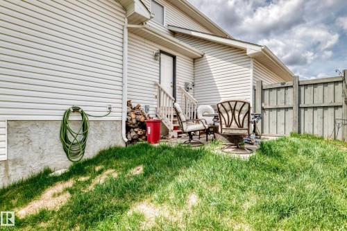Exterior featuring horizontal siding, a private patio area, and partial fencing - 5107 200 Street, Edmonton, AB - Outdoor