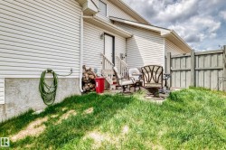 Exterior featuring horizontal siding, a private patio area, and partial fencing - 