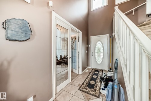 Foyer featuring a white front door with an oval decorative glass insert. - 5107 200 Street, Edmonton, AB - Indoor Photo Showing Other Room