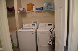 Dedicated laundry area with durable flooring - 