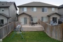 Rear exterior featuring a spacious wooden deck with steps to a grassy yard - 1412 152, Edmonton, AB  - Outdoor With Exterior 