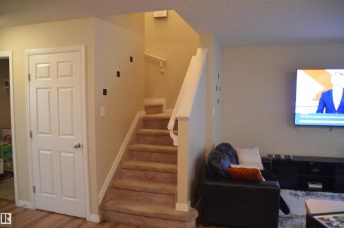 Carpeted staircase with white balustrade leading to an upper level - 1412 152, Edmonton, AB - Indoor Photo Showing Other Room