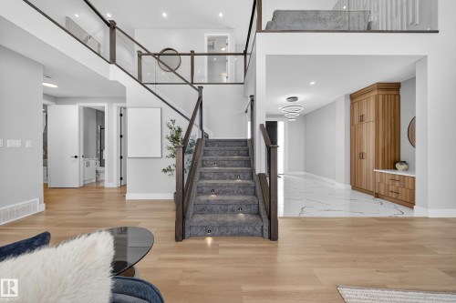 This property features an open-concept interior with light hardwood flooring on the main level - 6614 39 Avenue, Beaumont, AB - Indoor Photo Showing Other Room