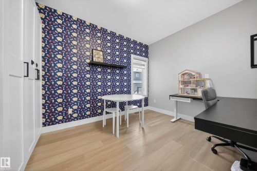 This room features light-toned flooring, a window providing natural light, and a prominent accent wall - 6614 39 Avenue, Beaumont, AB - Indoor Photo Showing Office