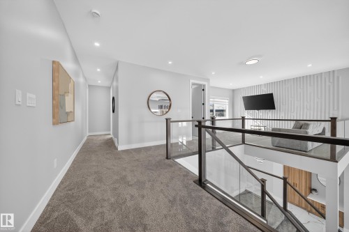The property features a spacious landing with plush grey carpeting and recessed lighting - 6614 39 Avenue, Beaumont, AB - Indoor Photo Showing Other Room