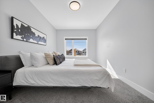 This room features light grey walls and grey carpet flooring - 6614 39 Avenue, Beaumont, AB - Indoor Photo Showing Bedroom