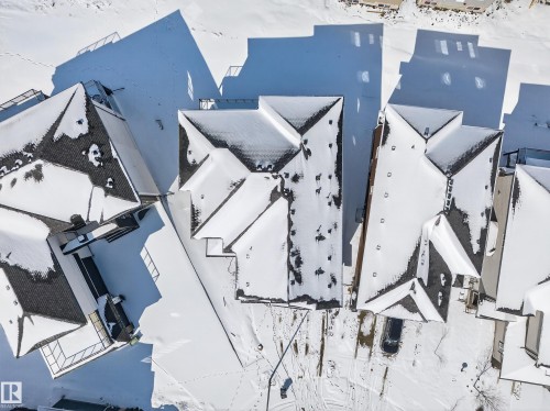 Aerial view showcasing the property's distinct roofline and surrounding snow-covered terrain - 6614 39 Avenue, Beaumont, AB - Outdoor With View