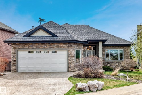 Stone veneer exterior with a multi-gabled roof and a decorative weathervane - 527 Callaghan Point(E), Edmonton, AB - Outdoor
