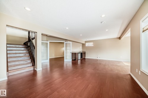 Expansive open-concept room featuring wood-finish flooring, recessed lighting, and neutral wall tones - 527 Callaghan Point(E), Edmonton, AB - Indoor Photo Showing Other Room