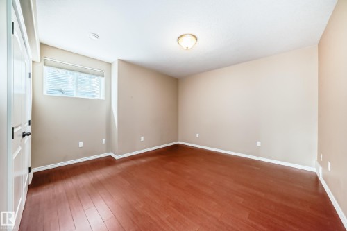 Room with wood-finish flooring, neutral wall tones, and a window with blinds - 527 Callaghan Point(E), Edmonton, AB - Indoor Photo Showing Other Room