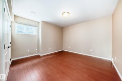 Room with wood-finish flooring, neutral wall tones, and a window with blinds - 