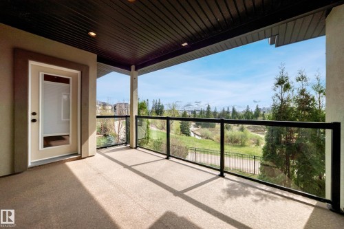 Covered patio with a painted concrete surface, recessed lighting, and a glass-paneled railing - 527 Callaghan Point(E), Edmonton, AB - Outdoor With Exterior