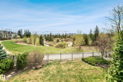 Expansive green space featuring a walking path, mature trees, and a distant stream - 527 Callaghan Point(E), Edmonton, AB - Outdoor