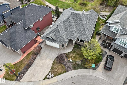 Contemporary residence featuring a multi-gabled roof, stone façade accents, an attached two-car garage, and a curved concrete driveway - 527 Callaghan Point(E), Edmonton, AB - Outdoor