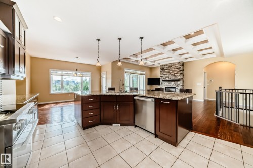 Kitchen featuring a multi-level island with integrated sink, stainless steel appliances, and granite countertops - 527 Callaghan Point(E), Edmonton, AB - Indoor Photo Showing Kitchen With Upgraded Kitchen