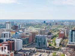 Urban skyline featuring diverse architectural styles, green spaces, and distant infrastructure - 
