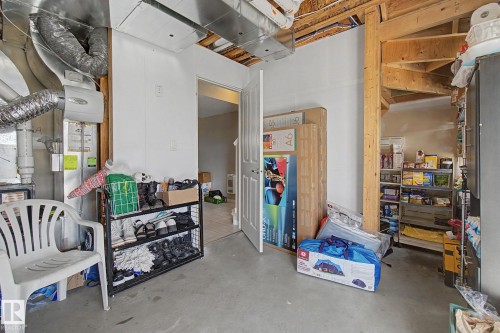 Unfinished utility space featuring exposed ductwork, exposed ceiling joists, and a concrete floor - 17 320 Secord Boulevard, Edmonton, AB - Indoor Photo Showing Other Room